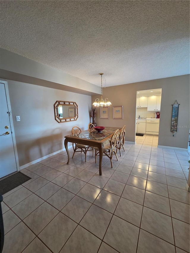 632 Edgewater Dr Unit 633, Dunedin, FL 34698 - dining space with light tile patterned floors, a chandelier, and a textured ceiling