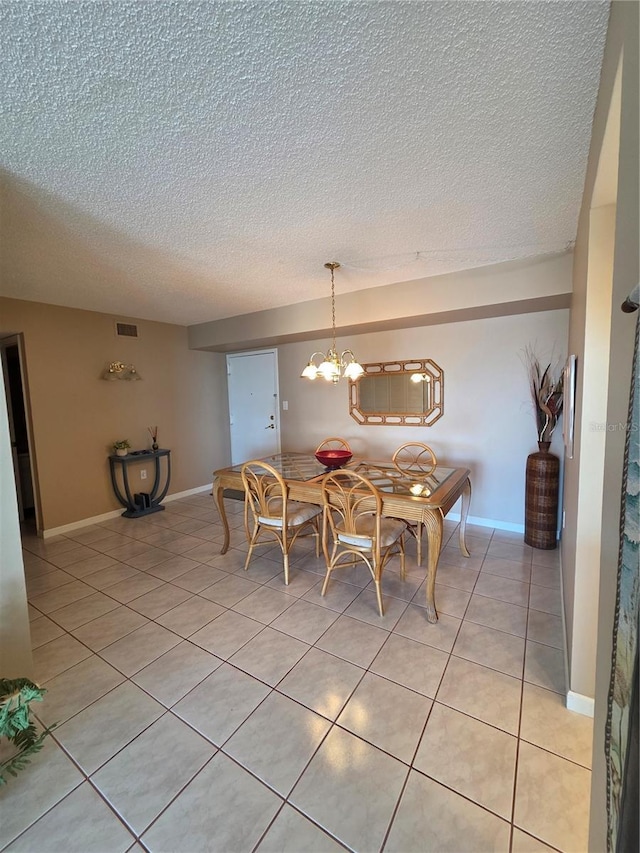 632 Edgewater Dr Unit 633, Dunedin, FL 34698 - dining area with a textured ceiling and light tile patterned floors