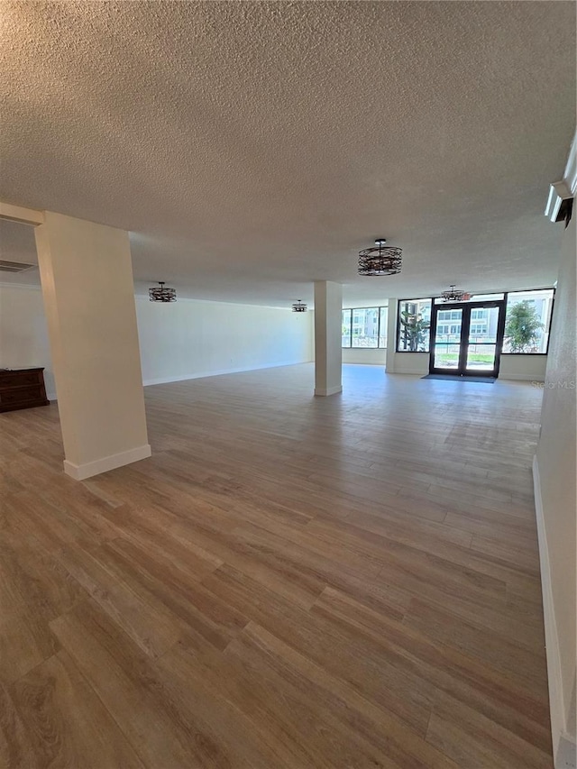 632 Edgewater Dr Unit 633, Dunedin, FL 34698 - below grade area featuring wood finished floors, a textured ceiling, and a chandelier