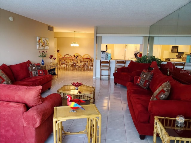 632 Edgewater Dr Unit 633, Dunedin, FL 34698 - tiled living area with a chandelier and a textured ceiling