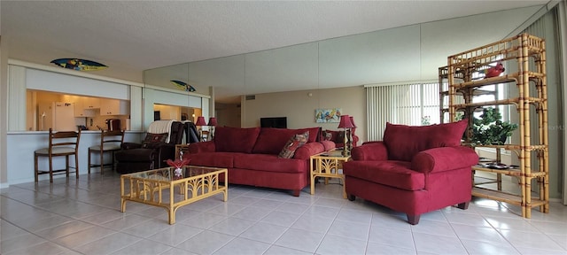632 Edgewater Dr Unit 633, Dunedin, FL 34698 - tiled living room with a textured ceiling