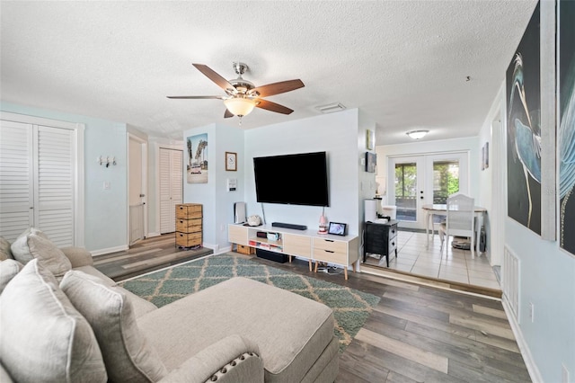 908 Toddsmill Trce, Tarpon Springs, FL 34689 - living area featuring wood finished floors, french doors, a ceiling fan, and a textured ceiling