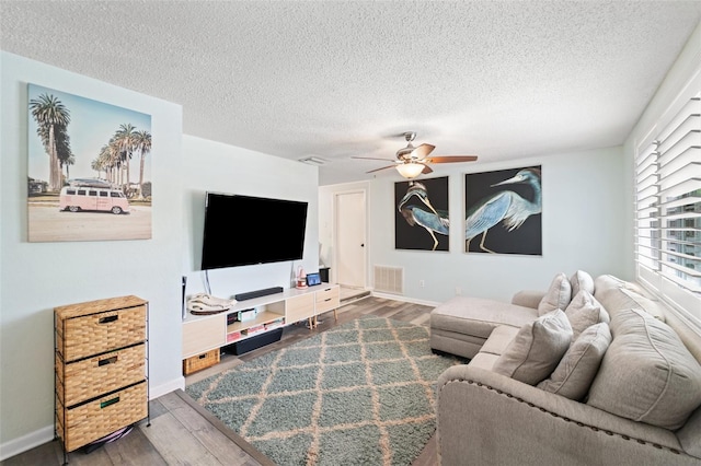 908 Toddsmill Trce, Tarpon Springs, FL 34689 - living room featuring wood finished floors, a ceiling fan, and a textured ceiling