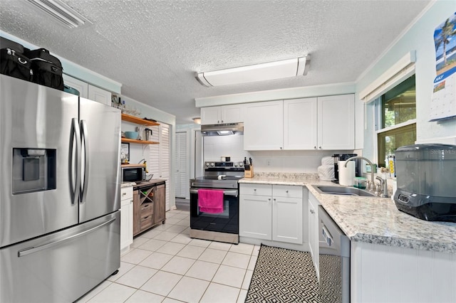 908 Toddsmill Trce, Tarpon Springs, FL 34689 - kitchen featuring appliances with stainless steel finishes, under cabinet range hood, open shelves, light tile patterned flooring, and a textured ceiling
