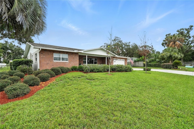 5628 Cypress St, Zephyrhills, FL 33542 - ranch-style house with an attached garage, brick siding, a front yard, and concrete driveway
