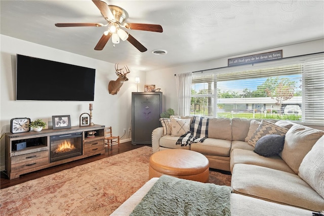 5628 Cypress St, Zephyrhills, FL 33542 - living room with wood finished floors and ceiling fan