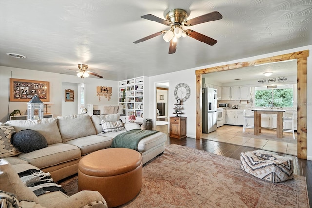 5628 Cypress St, Zephyrhills, FL 33542 - living area with ceiling fan, light wood finished floors, and built in features