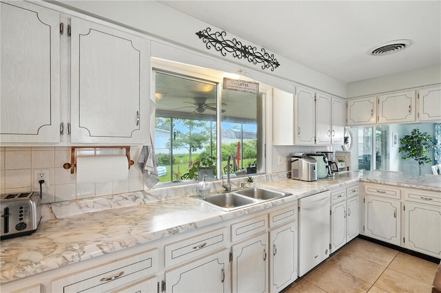 5628 Cypress St, Zephyrhills, FL 33542 - kitchen with white dishwasher, ceiling fan, decorative backsplash, and light countertops