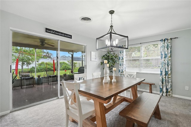 5628 Cypress St, Zephyrhills, FL 33542 - carpeted dining room with plenty of natural light, a chandelier, and a ceiling fan