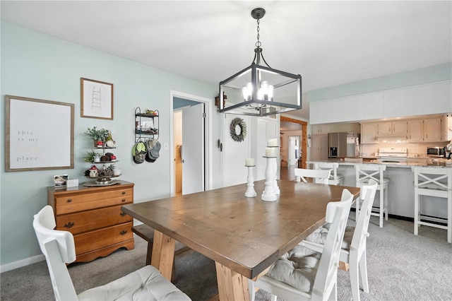 5628 Cypress St, Zephyrhills, FL 33542 - dining area featuring a chandelier and light carpet
