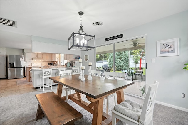 5628 Cypress St, Zephyrhills, FL 33542 - dining area featuring a chandelier, light carpet, and a ceiling fan