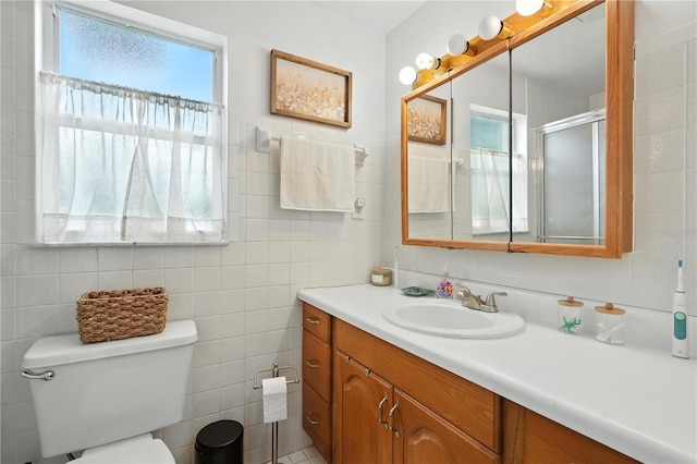 5628 Cypress St, Zephyrhills, FL 33542 - bathroom with vanity, tile walls, and a shower with door
