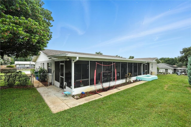 5628 Cypress St, Zephyrhills, FL 33542 - back of house with a sunroom and a gate