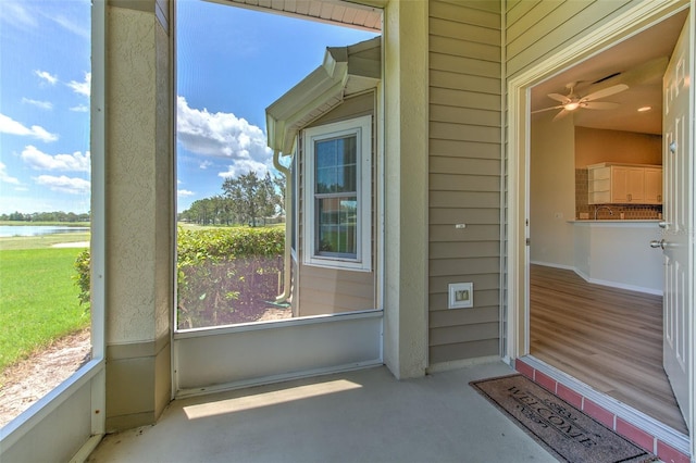 2012 Fall River Ct Unit 107, Sun City Center, FL 33573 - unfurnished sunroom with a water view and ceiling fan