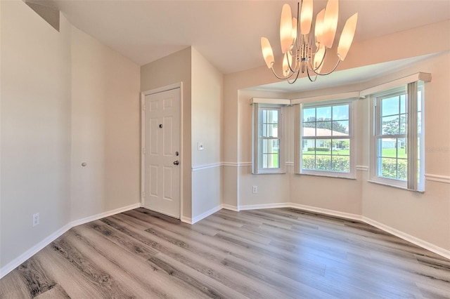 2012 Fall River Ct Unit 107, Sun City Center, FL 33573 - unfurnished dining area featuring wood finished floors and a chandelier