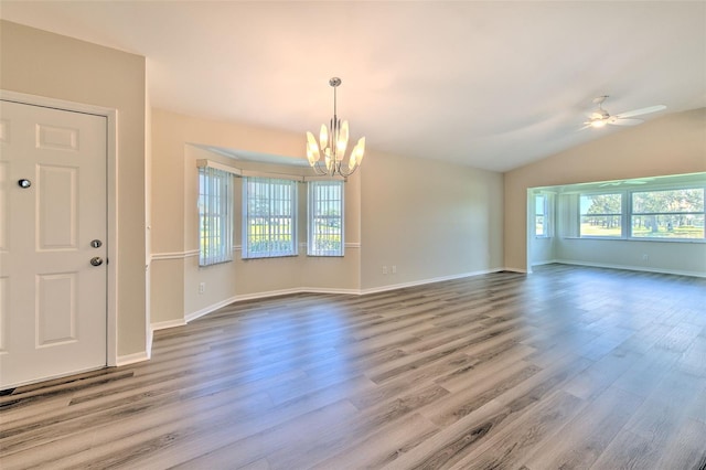 2012 Fall River Ct Unit 107, Sun City Center, FL 33573 - unfurnished room featuring a chandelier, a ceiling fan, wood finished floors, and lofted ceiling