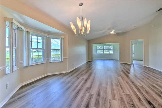 2012 Fall River Ct Unit 107, Sun City Center, FL 33573 - empty room with a chandelier, wood finished floors, vaulted ceiling, and a ceiling fan