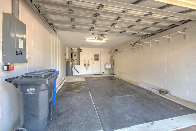2012 Fall River Ct Unit 107, Sun City Center, FL 33573 - garage featuring electric panel, concrete block wall, and a garage door opener