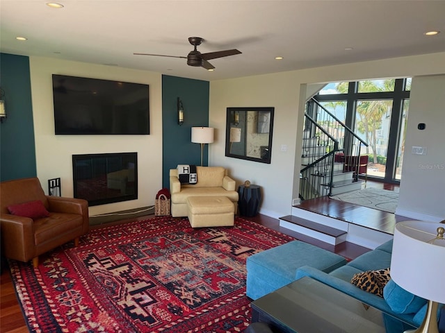 850 59th Ave, Saint Petersburg, FL 33706 - living area featuring a ceiling fan, stairway, a glass covered fireplace, recessed lighting, and wood finished floors