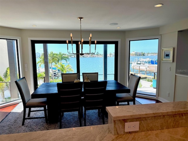 850 59th Ave, Saint Petersburg, FL 33706 - dining room featuring a chandelier, healthy amount of natural light, recessed lighting, and a water view