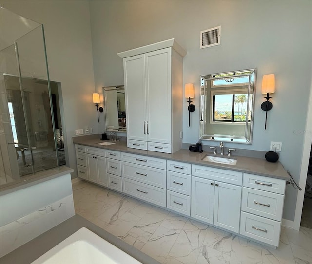 850 59th Ave, Saint Petersburg, FL 33706 - bathroom featuring a high ceiling, marble finish flooring, double vanity, a shower with shower door, and a tub to relax in