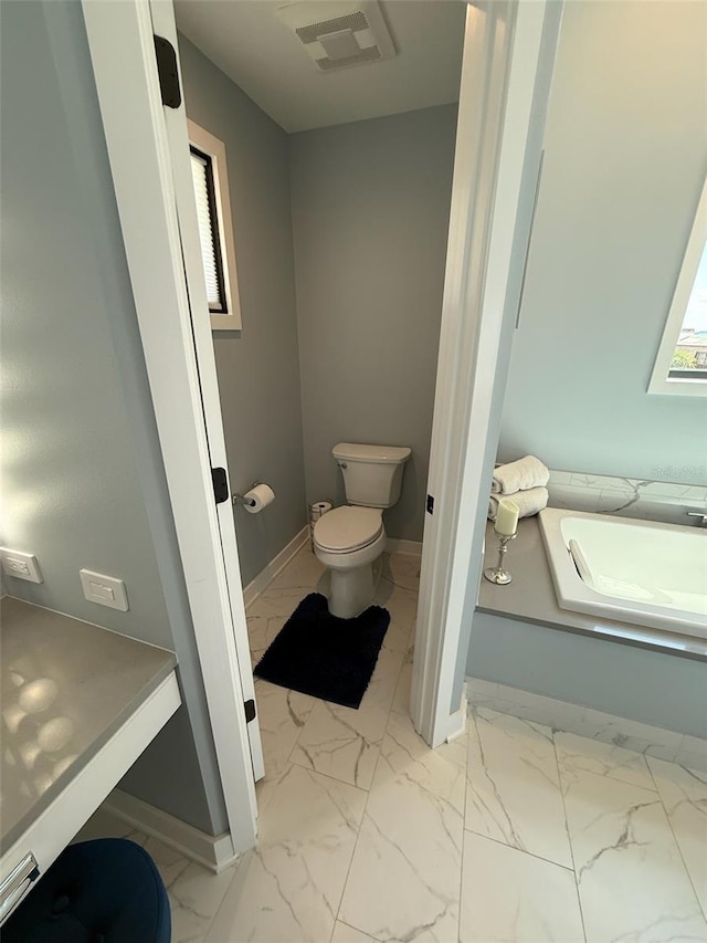 850 59th Ave, Saint Petersburg, FL 33706 - bathroom featuring toilet and marble look tile flooring