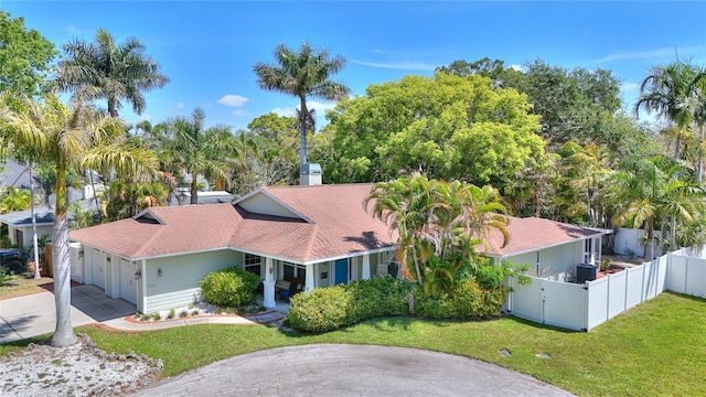 14 Evonaire Cir, Belleair, FL 33756 - mediterranean / spanish house with driveway, an attached garage, and a shingled roof