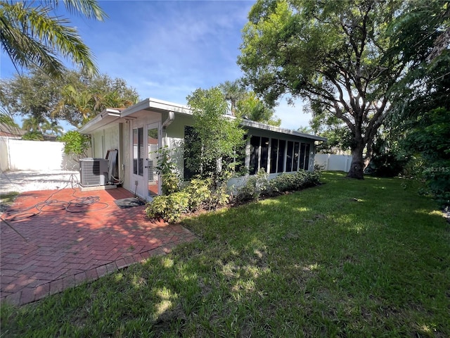 14 Evonaire Cir, Belleair, FL 33756 - view of side of home featuring a patio area, a fenced backyard, and a sunroom
