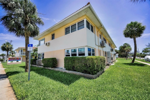 7740 Boca Ciega Dr Unit 204, St Pete Beach, FL 33706 - view of side of home featuring stucco siding and a lawn
