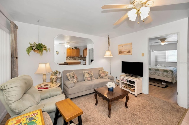 7740 Boca Ciega Dr Unit 204, St Pete Beach, FL 33706 - living room featuring ceiling fan and light wood-style floors