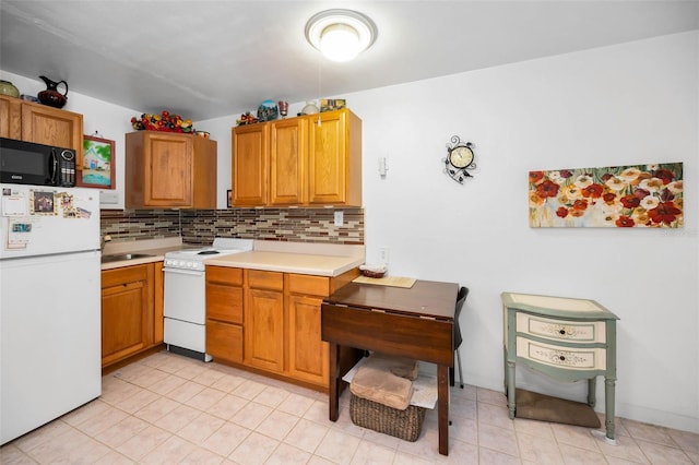 7740 Boca Ciega Dr Unit 204, St Pete Beach, FL 33706 - kitchen featuring white appliances, light countertops, decorative backsplash, and light tile patterned floors