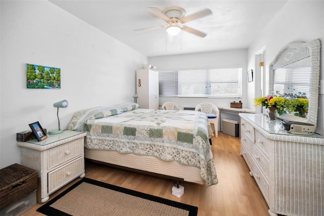 7740 Boca Ciega Dr Unit 204, St Pete Beach, FL 33706 - bedroom featuring light wood-style flooring and a ceiling fan