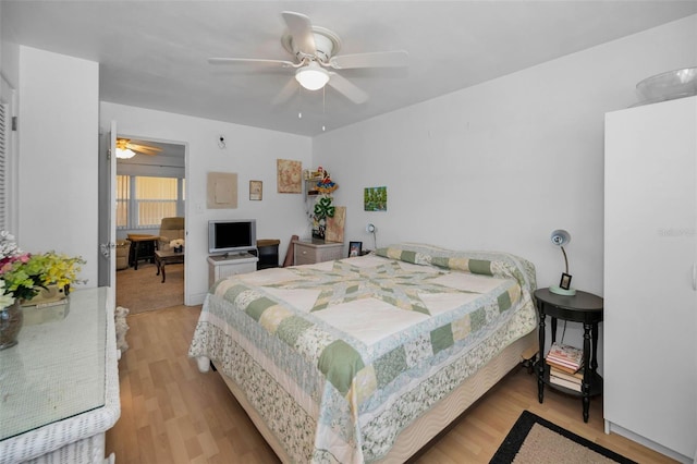 7740 Boca Ciega Dr Unit 204, St Pete Beach, FL 33706 - bedroom featuring light wood-style floors and a ceiling fan