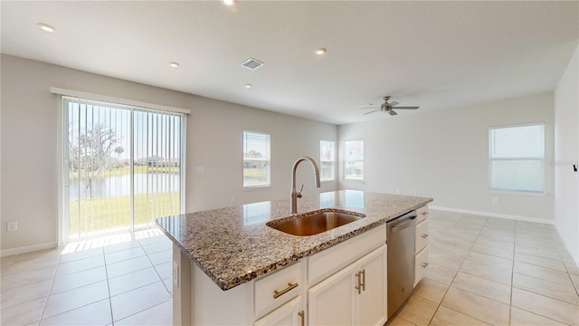 10827 High Noon Trl, Parrish, FL 34219 - kitchen with dishwasher, ceiling fan, light tile patterned floors, light stone counters, and recessed lighting