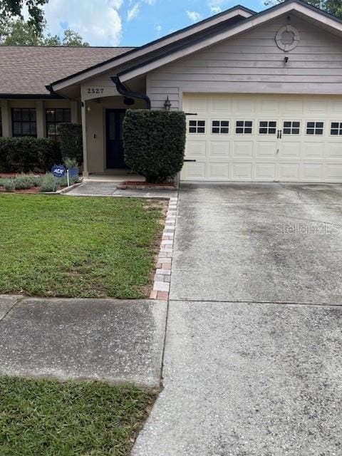 2527 Arborwood Dr, Valrico, FL 33596 - single story home with concrete driveway, a front lawn, and a garage