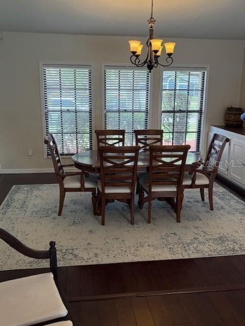 2527 Arborwood Dr, Valrico, FL 33596 - dining area featuring dark wood finished floors and a chandelier