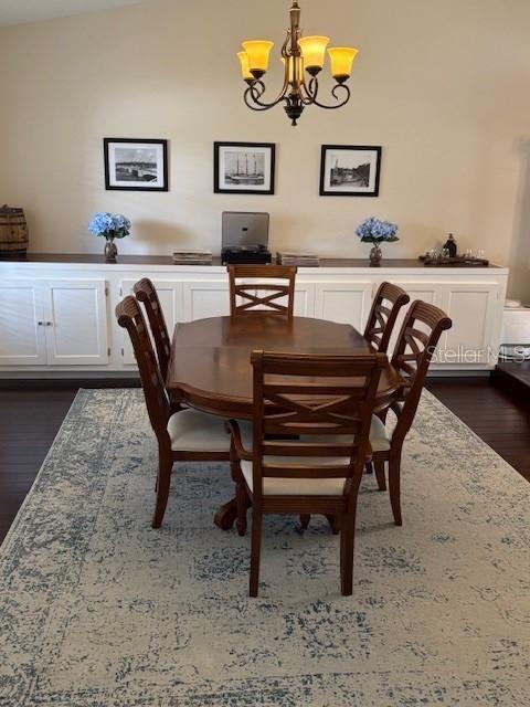 2527 Arborwood Dr, Valrico, FL 33596 - dining area featuring a chandelier and dark wood-type flooring