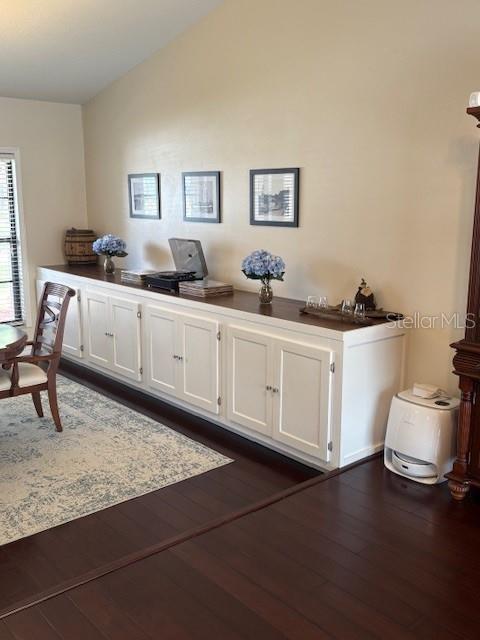2527 Arborwood Dr, Valrico, FL 33596 - office area with dark wood-style flooring and vaulted ceiling