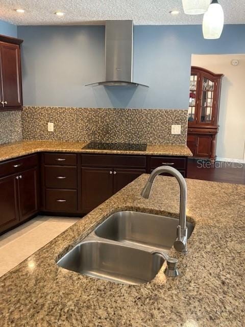 2527 Arborwood Dr, Valrico, FL 33596 - kitchen featuring wall chimney exhaust hood, black electric cooktop, light stone countertops, a textured ceiling, and backsplash