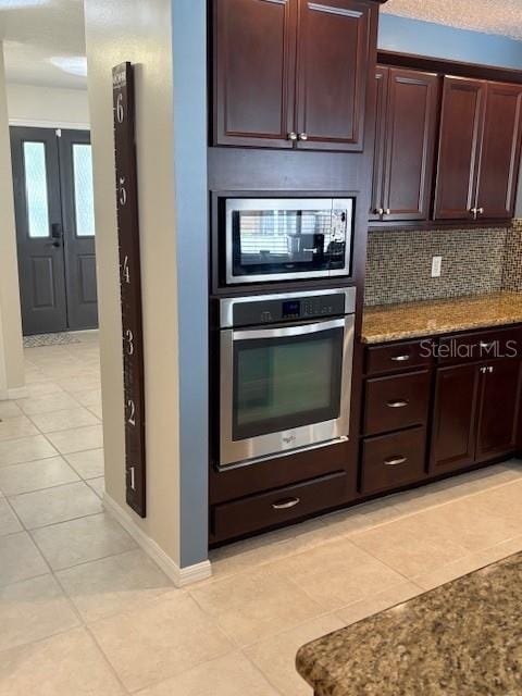 2527 Arborwood Dr, Valrico, FL 33596 - kitchen featuring stainless steel appliances, light tile patterned floors, tasteful backsplash, and stone countertops