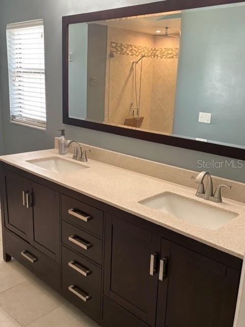 2527 Arborwood Dr, Valrico, FL 33596 - bathroom featuring double vanity, a shower stall, and tile patterned floors