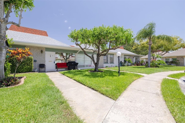 4357 Tahitian Gardens Cir Unit B, Holiday, FL 34691 - ranch-style house with a front yard and stucco siding