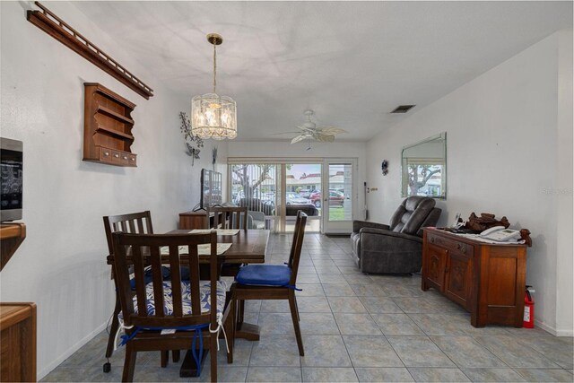 4357 Tahitian Gardens Cir Unit B, Holiday, FL 34691 - dining room featuring ceiling fan, a chandelier, and light tile patterned floors