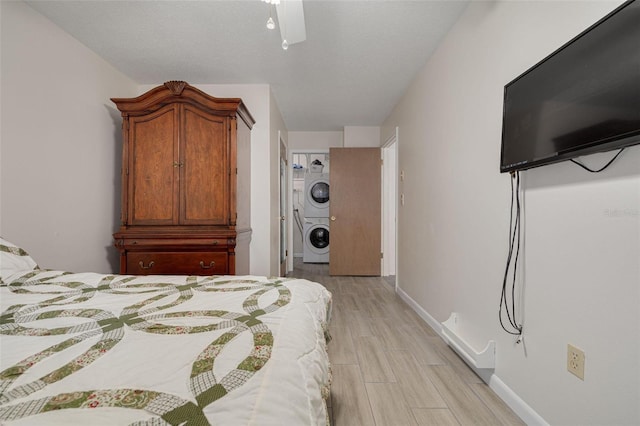 4357 Tahitian Gardens Cir Unit B, Holiday, FL 34691 - bedroom with stacked washer and clothes dryer and wood finish floors