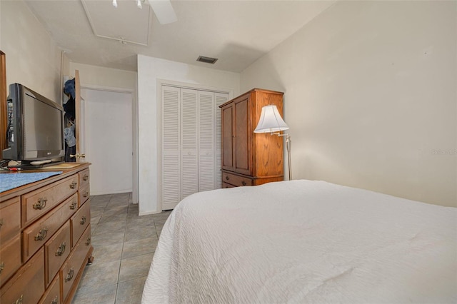 4357 Tahitian Gardens Cir Unit B, Holiday, FL 34691 - bedroom featuring a closet, light tile patterned floors, a ceiling fan, and attic access