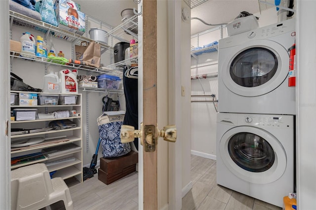 4357 Tahitian Gardens Cir Unit B, Holiday, FL 34691 - washroom featuring stacked washer / dryer and baseboards
