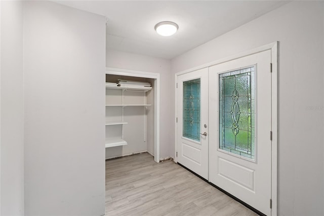 1712 Robin Hood Ln, Clearwater, FL 33764 - foyer entrance with light wood-type flooring and french doors