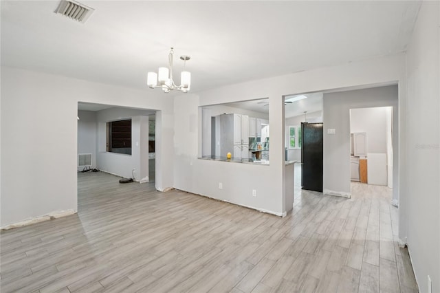 1712 Robin Hood Ln, Clearwater, FL 33764 - empty room featuring light wood-type flooring and a chandelier