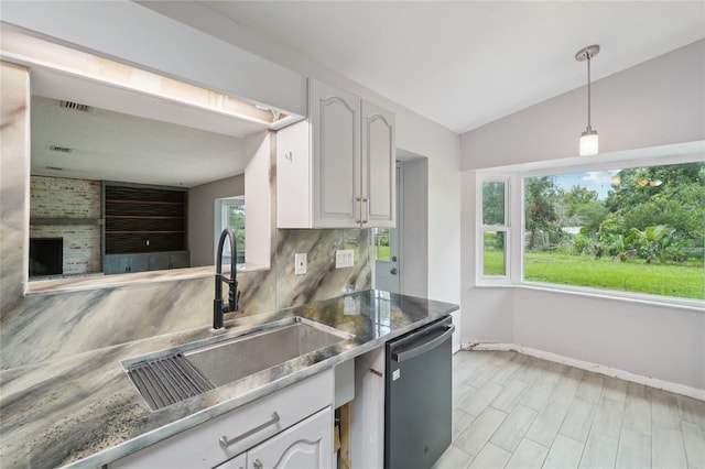 1712 Robin Hood Ln, Clearwater, FL 33764 - kitchen featuring dishwasher, white cabinetry, tasteful backsplash, hanging light fixtures, and lofted ceiling
