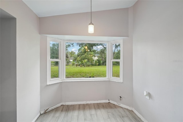 1712 Robin Hood Ln, Clearwater, FL 33764 - unfurnished dining area with baseboards and wood finished floors